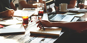 Close up of table with notebooks and a laptop